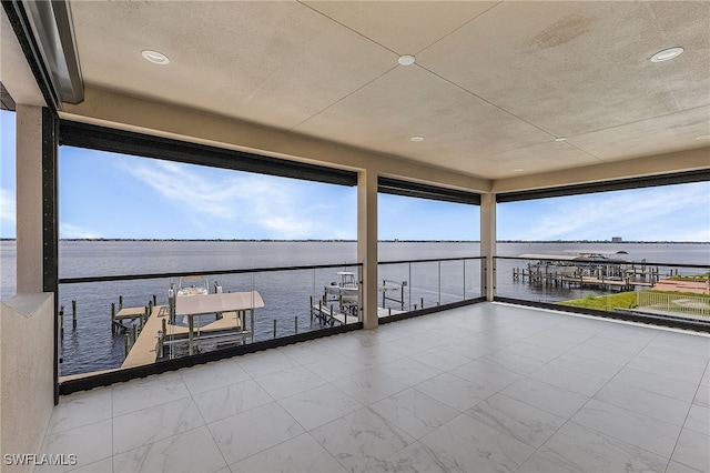 view of dock with a water view and a balcony