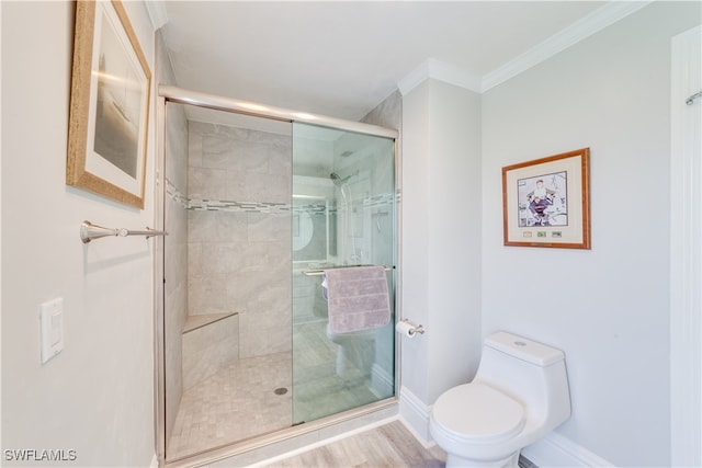 bathroom featuring ornamental molding, hardwood / wood-style flooring, walk in shower, and toilet