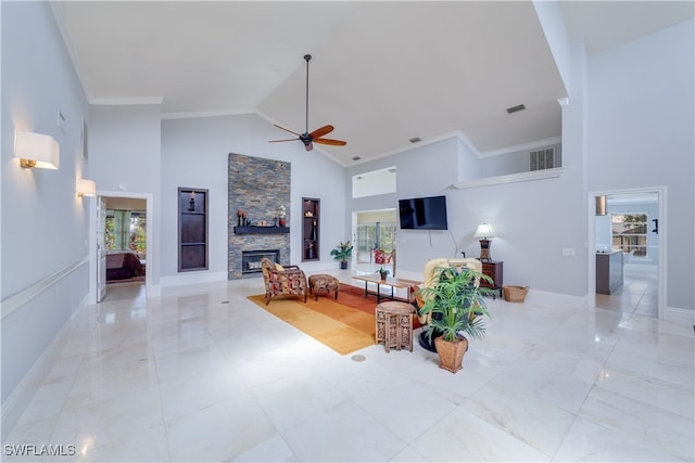 living room with ceiling fan, a fireplace, ornamental molding, and high vaulted ceiling