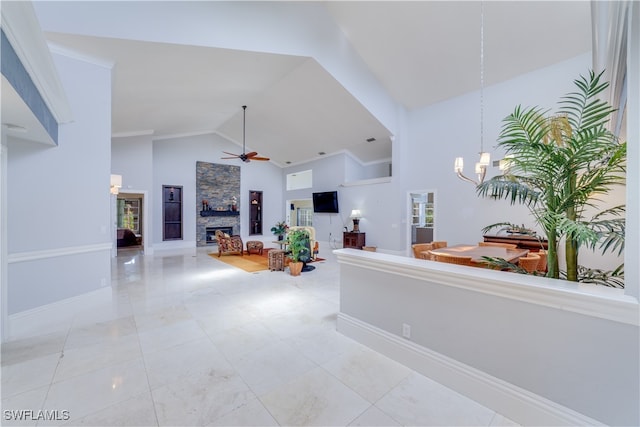 interior space featuring an inviting chandelier, ornamental molding, and high vaulted ceiling