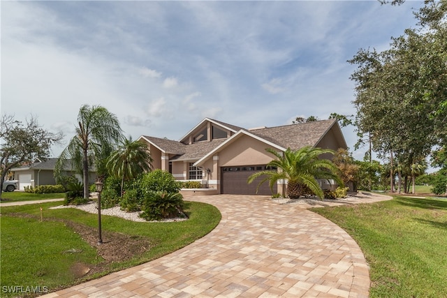 view of front of home featuring a garage and a front lawn