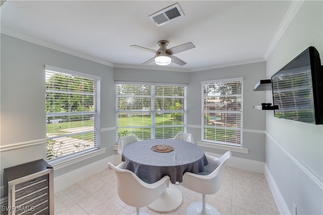 tiled dining space with ceiling fan, wine cooler, and ornamental molding