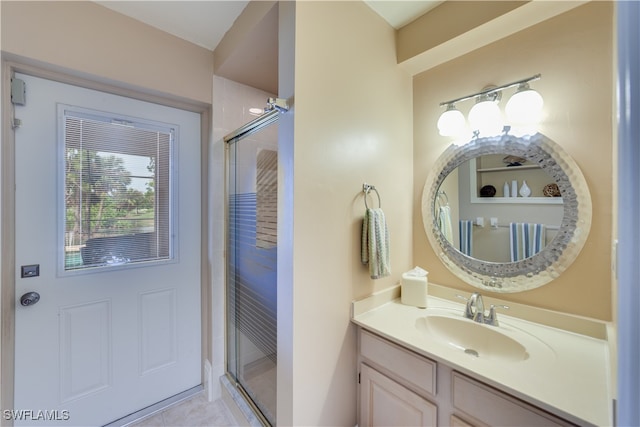 bathroom with vanity, tile patterned flooring, and a shower with door