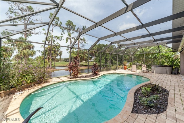 view of pool with glass enclosure and a patio