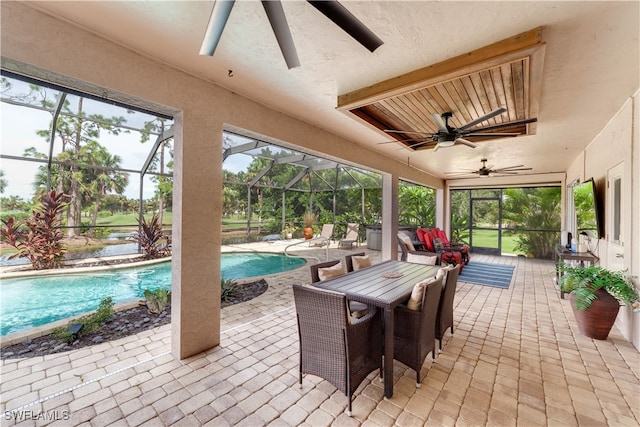 view of patio / terrace featuring a lanai and ceiling fan