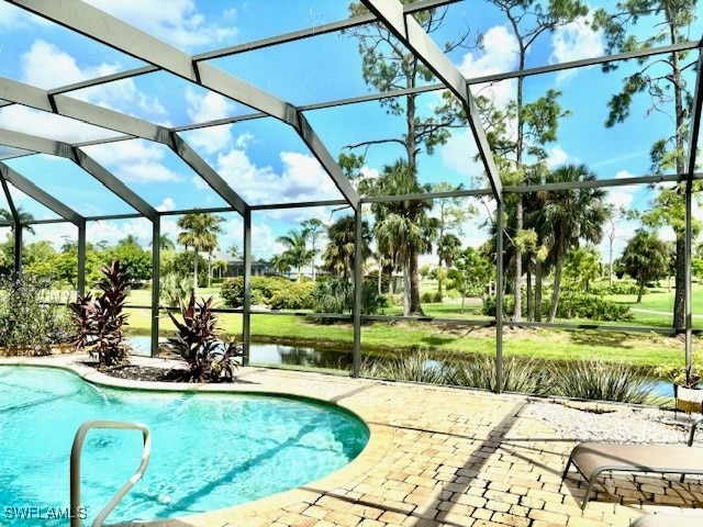 view of swimming pool with a water view, a patio, and a lanai