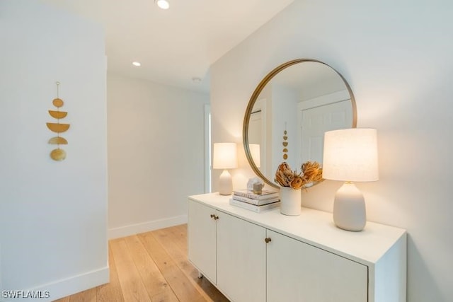 hallway with recessed lighting, baseboards, and light wood finished floors