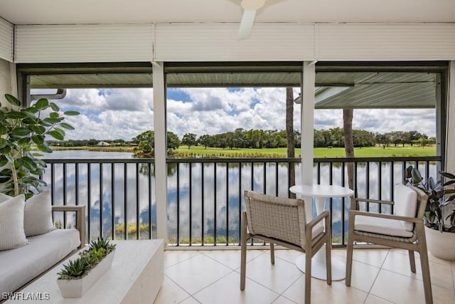 sunroom / solarium with a wealth of natural light and a water view