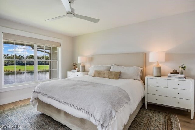 bedroom with ceiling fan and dark hardwood / wood-style flooring