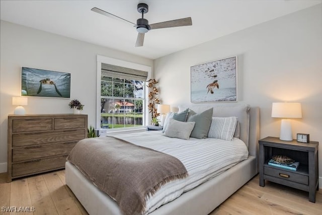 bedroom with ceiling fan and light hardwood / wood-style floors