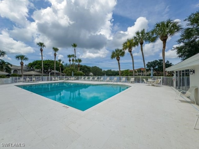 pool featuring a patio area and fence