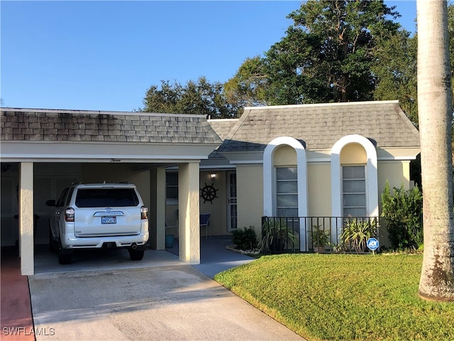 ranch-style home featuring a front yard and a carport