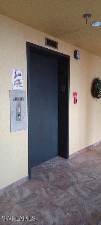 garage with elevator and visible vents