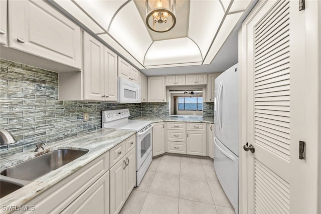 kitchen featuring sink, light tile patterned floors, white appliances, decorative backsplash, and white cabinets