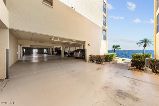 garage featuring a water view and driveway