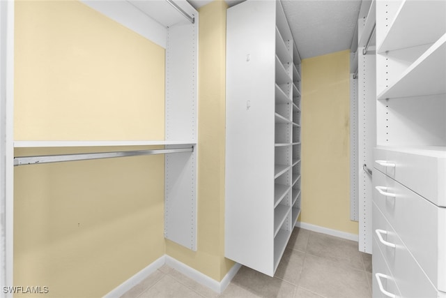 spacious closet with light tile patterned floors