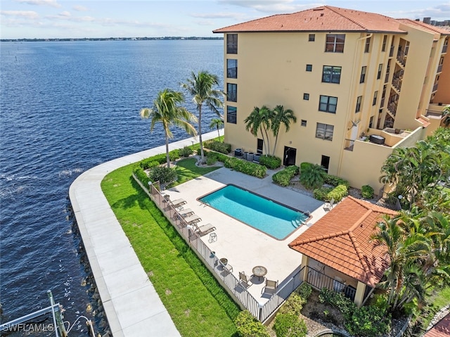 view of pool featuring a patio and a water view