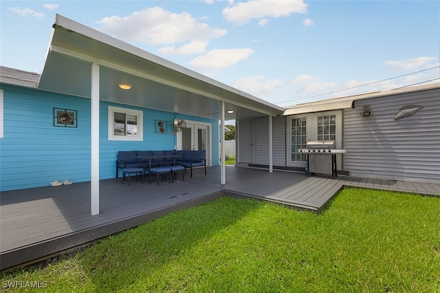 back of property featuring a lawn, a wooden deck, and an outdoor hangout area