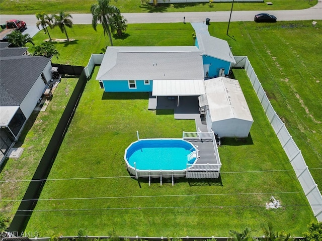 view of pool featuring a yard