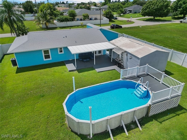 view of pool featuring a wooden deck and a yard