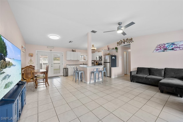 living room with light tile patterned flooring and ceiling fan