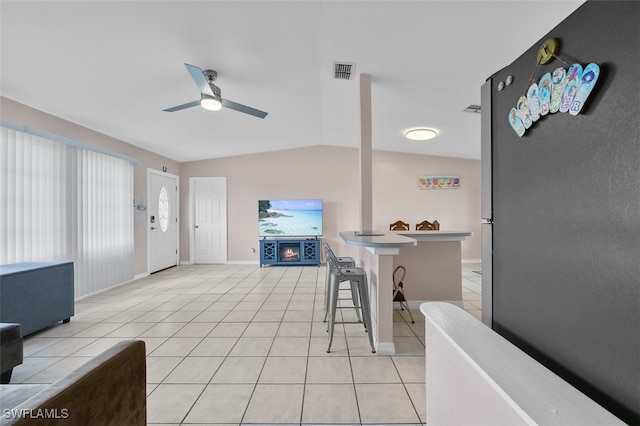 interior space featuring lofted ceiling and ceiling fan