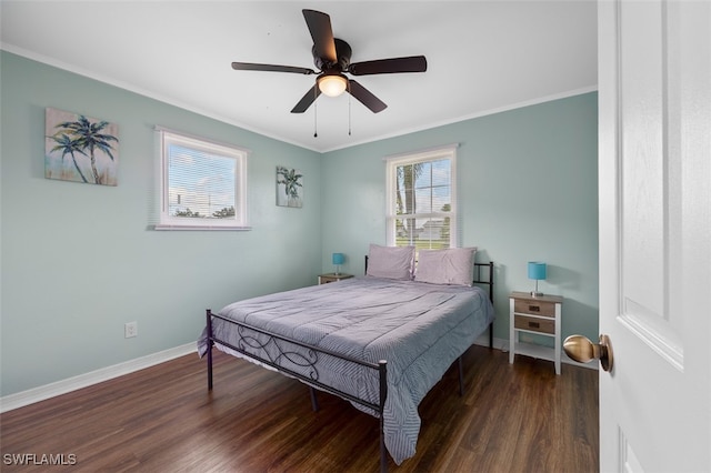 bedroom with ornamental molding, dark hardwood / wood-style flooring, and ceiling fan