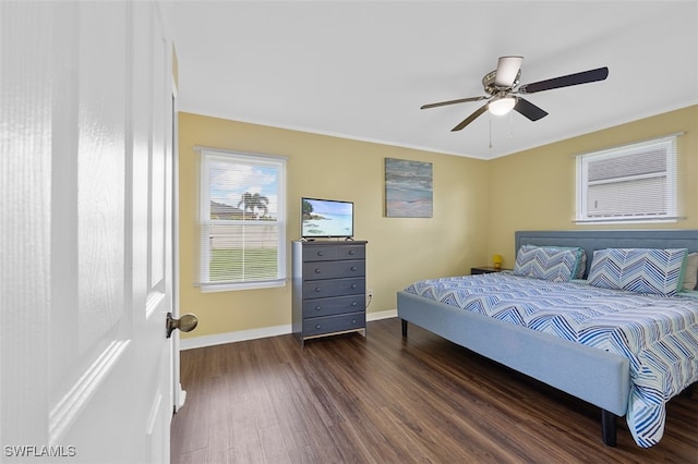 bedroom featuring dark wood-type flooring, ceiling fan, and ornamental molding