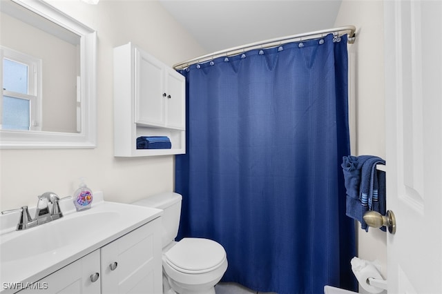 bathroom with walk in shower, toilet, and vanity