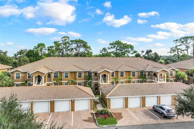 view of front of property with a garage and a balcony