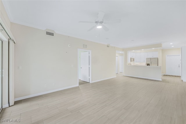 unfurnished living room with ornamental molding, ceiling fan, and light hardwood / wood-style floors