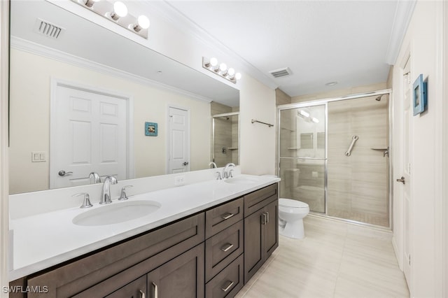 bathroom featuring ornamental molding, vanity, toilet, and a shower with door