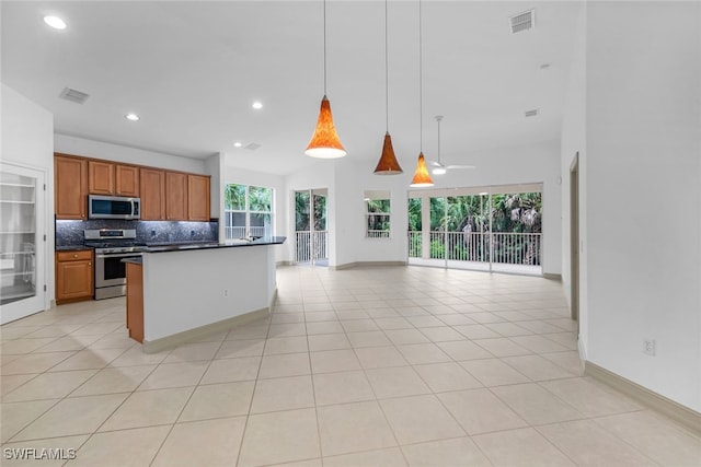 kitchen featuring ceiling fan, stainless steel appliances, pendant lighting, decorative backsplash, and light tile patterned floors