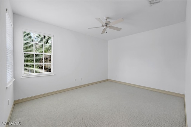 empty room featuring ceiling fan and carpet floors