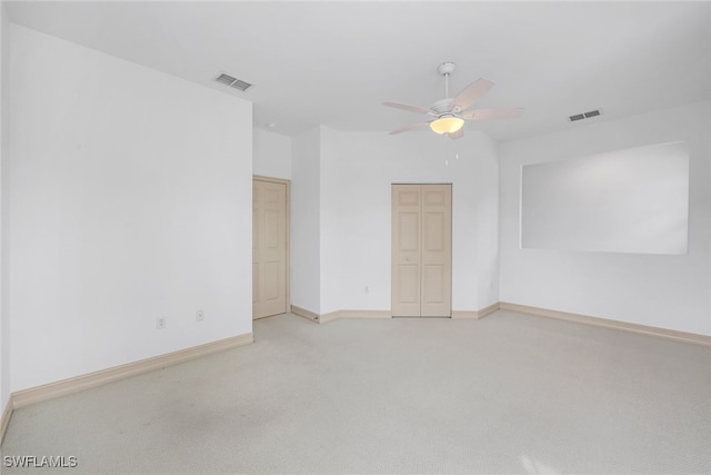 carpeted empty room with ceiling fan