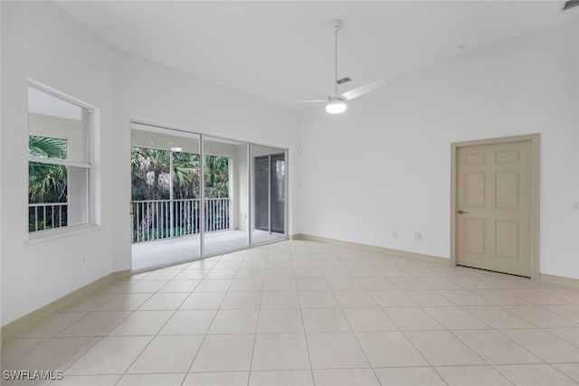 tiled spare room with ceiling fan and lofted ceiling