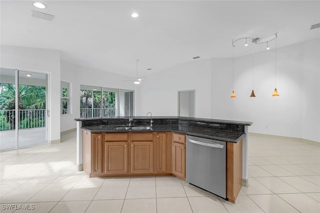 kitchen featuring stainless steel dishwasher, a kitchen island with sink, and dark stone countertops