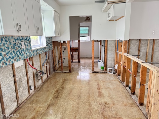 kitchen featuring white cabinets and plenty of natural light