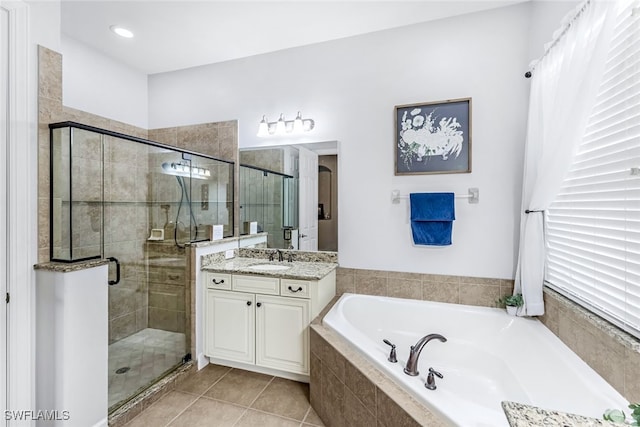 bathroom featuring tile patterned flooring, independent shower and bath, and vanity