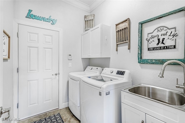 clothes washing area featuring separate washer and dryer, crown molding, cabinets, and sink