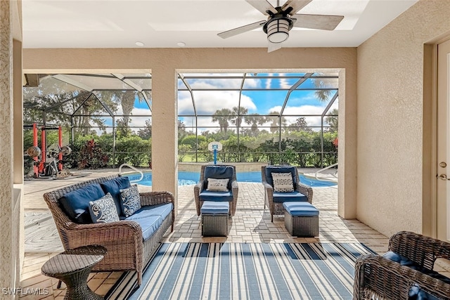 view of patio / terrace featuring ceiling fan and a lanai