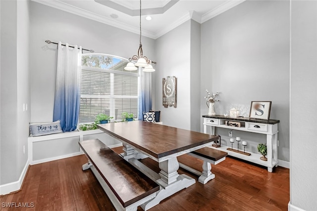 dining space with dark hardwood / wood-style flooring and ornamental molding