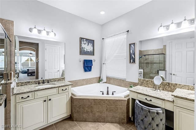 bathroom with tile patterned flooring, vanity, separate shower and tub, and ceiling fan