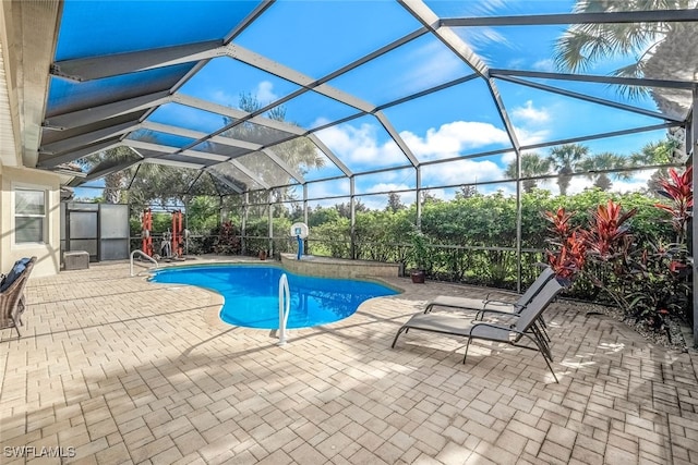 view of swimming pool featuring a lanai and a patio