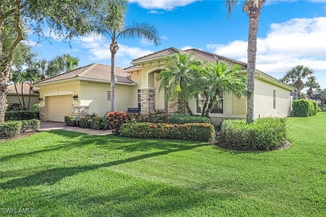 mediterranean / spanish-style home featuring a garage and a front yard