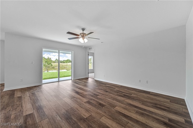 empty room featuring dark wood-type flooring and ceiling fan