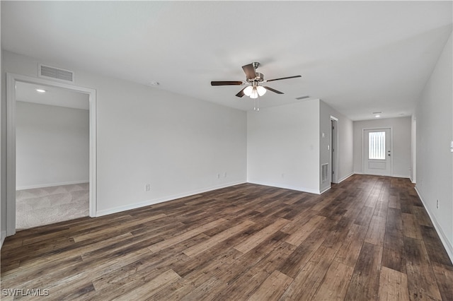 unfurnished living room with ceiling fan and dark wood-type flooring