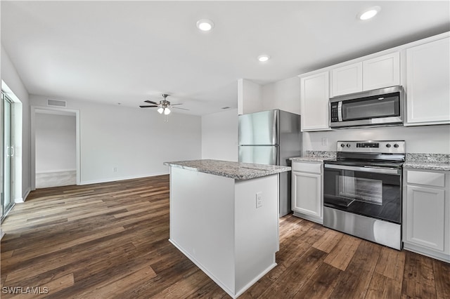 kitchen featuring stainless steel appliances, white cabinets, ceiling fan, and dark hardwood / wood-style floors