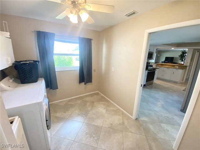 laundry room with cabinets, ceiling fan, light tile patterned floors, and washer and dryer