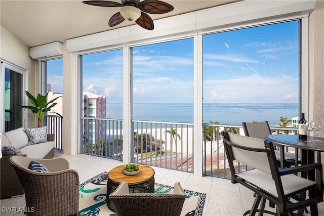 sunroom / solarium featuring a water view, an AC wall unit, and ceiling fan